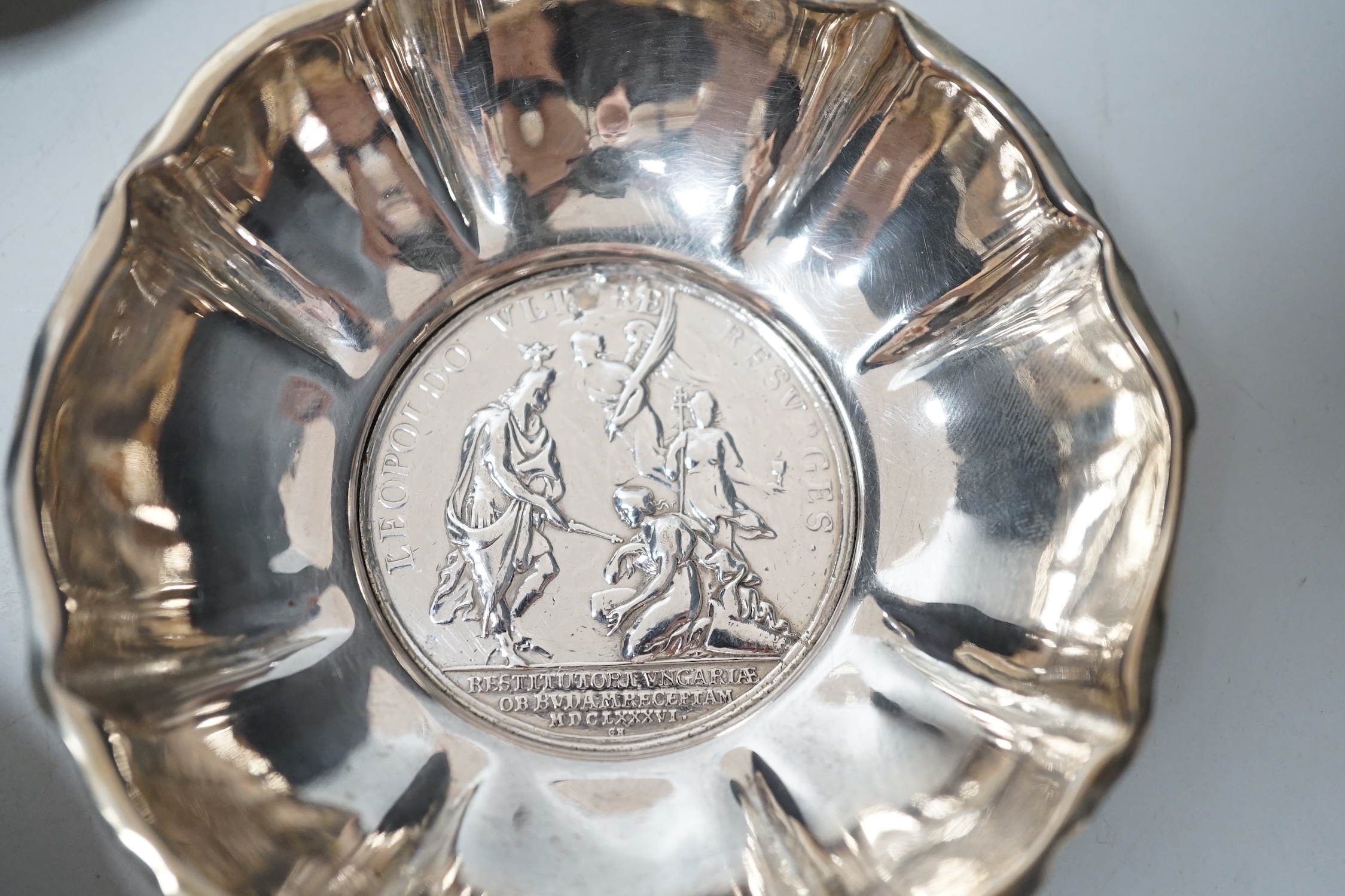 A 20th century Hungarian 800 standard white metal oval platter or stand, 33.2cm, and two 800 white metal bowls with inset coin bases, gross weight 15.5oz.